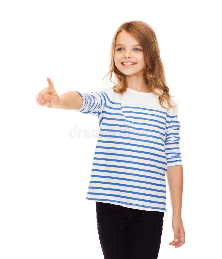 Education, school and virtual screen concept - cute little girl pointing in the air or virtual screen. Education, school and virtual screen concept - cute little girl pointing in the air or virtual screen