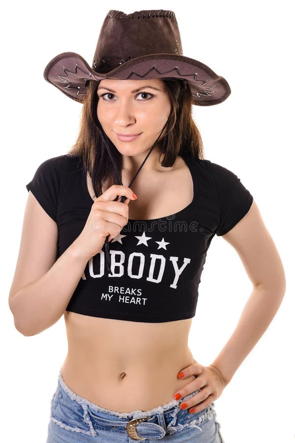 Muchacha morena delgada hermosa en un sombrero de vaquero fotos de archivo libres de regalías Muchacha morena delgada hermosa en un sombrero de vaquero fotos de archivo libres de regalías