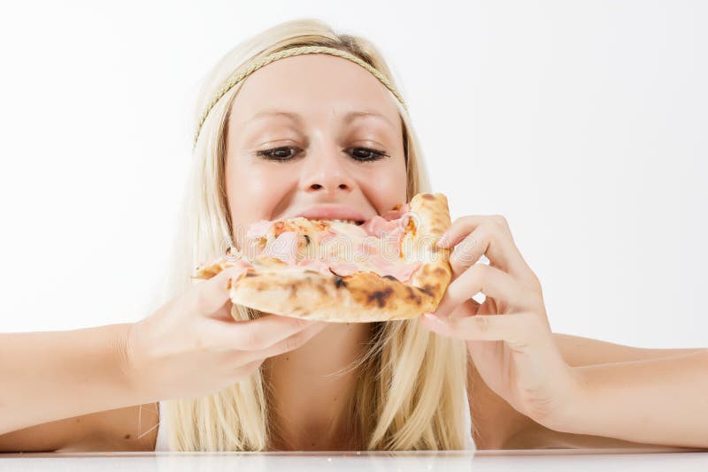 Muchacha que come la pizza imagen de archivo Muchacha que come la pizza imagen de archivo