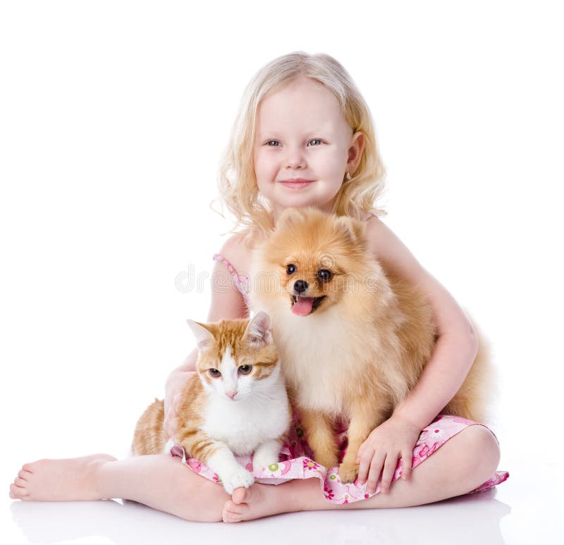 Girl playing with pets - dog and cat. looking away. isolated on. Girl playing with pets - dog and cat. looking away. isolated on