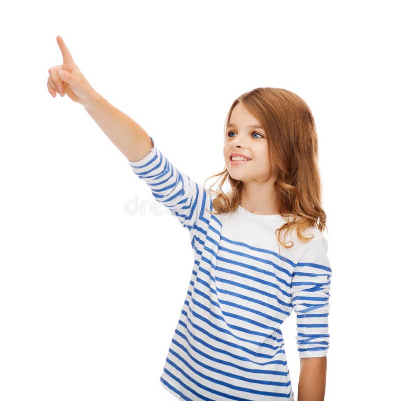 Education, school and virtual screen concept - cute little girl pointing in the air or virtual screen. Education, school and virtual screen concept - cute little girl pointing in the air or virtual screen