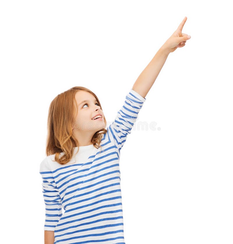 Education, school and virtual screen concept - cute little girl pointing in the air or virtual screen. Education, school and virtual screen concept - cute little girl pointing in the air or virtual screen