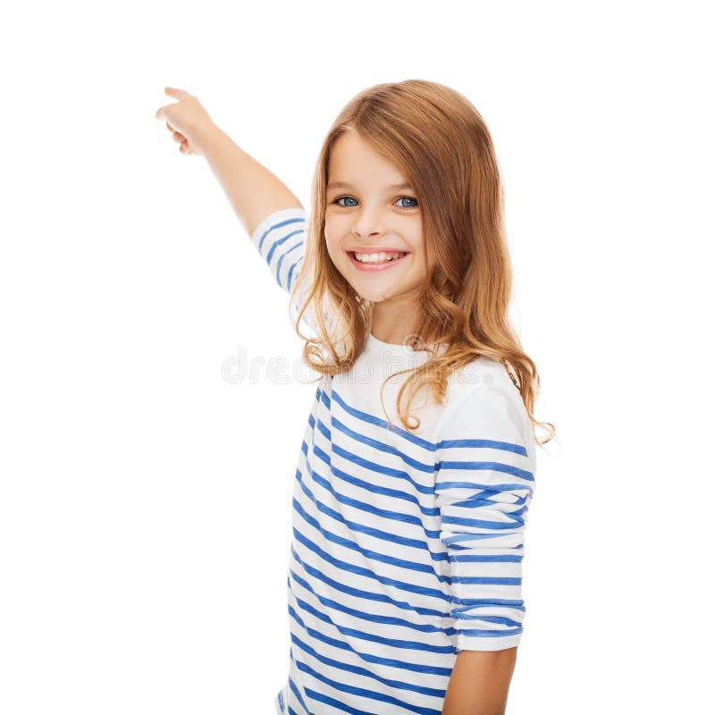 Education, school and virtual screen concept - cute little girl pointing in the air or virtual screen. Education, school and virtual screen concept - cute little girl pointing in the air or virtual screen