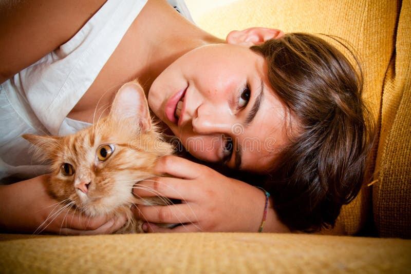 A young girl with her long-haired ginger cat. A young girl with her long-haired ginger cat.