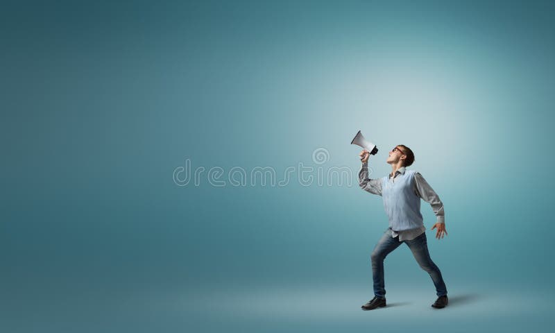 Teenager boy in glasses screaming emotional in megaphone. Teenager boy in glasses screaming emotional in megaphone