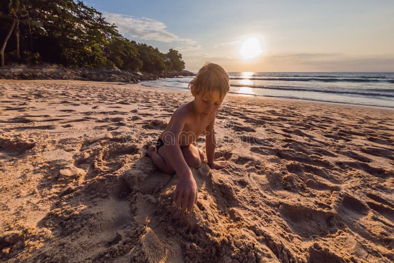 Muchacho lindo feliz que juega en la playa fotografía de archivo Muchacho lindo feliz que juega en la playa fotografía de archivo