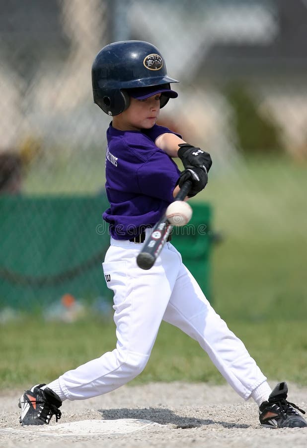 Boy hitting baseball and making contact. Boy hitting baseball and making contact