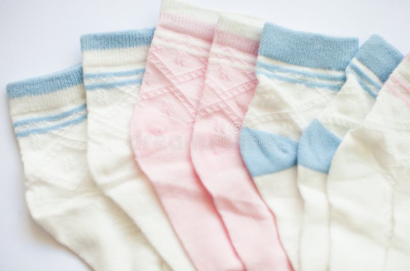Many pairs of child`s pink and blue striped socks. Many pairs of child`s pink and blue striped socks.