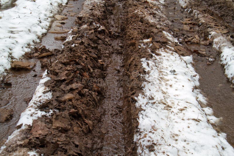 Mud and snow on a path stock photo. Image of muddy, snow 64873704