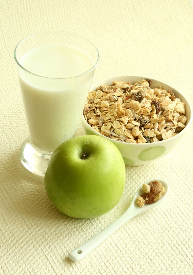 muesli, green apple and glass of milk