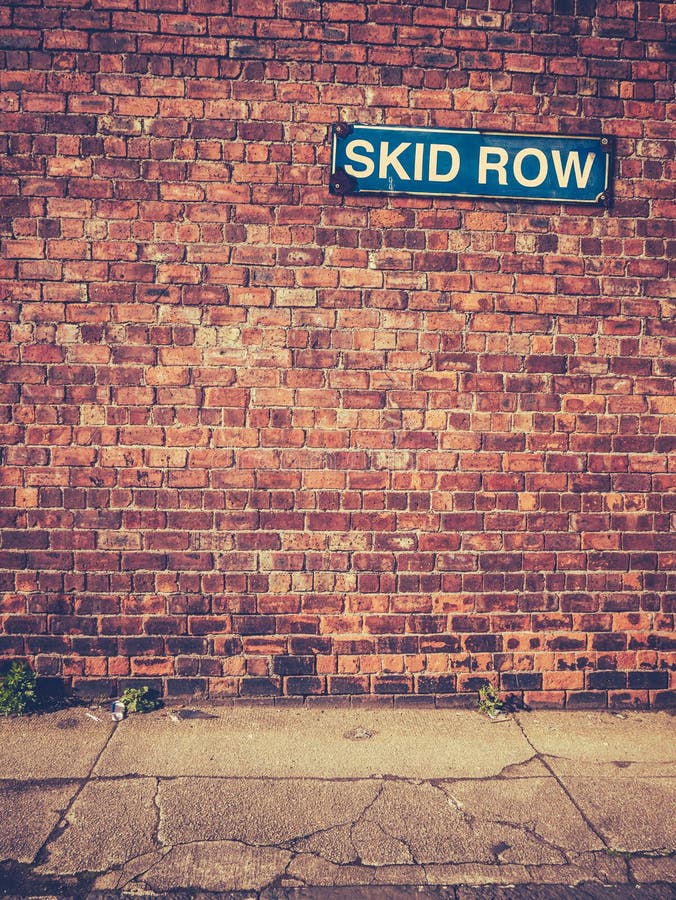 Urban Decay Image Of A Skid Row Sign On A Red Brick Wall. Urban Decay Image Of A Skid Row Sign On A Red Brick Wall