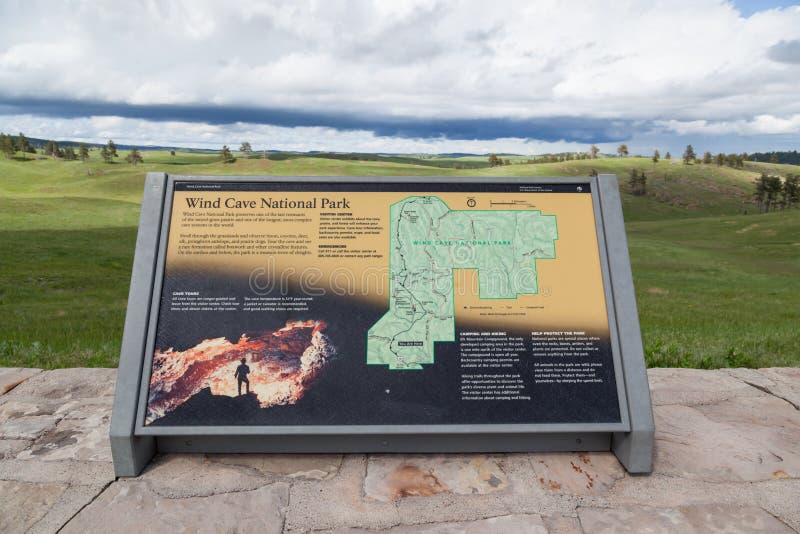 WIND CAVE NATIONAL PARK, SOUTH DAKOTA - June 11, 2014:  An informational sign showing a map with a dynamic background view in Wind Cave National Park, SD on June 11, 2014. WIND CAVE NATIONAL PARK, SOUTH DAKOTA - June 11, 2014:  An informational sign showing a map with a dynamic background view in Wind Cave National Park, SD on June 11, 2014.