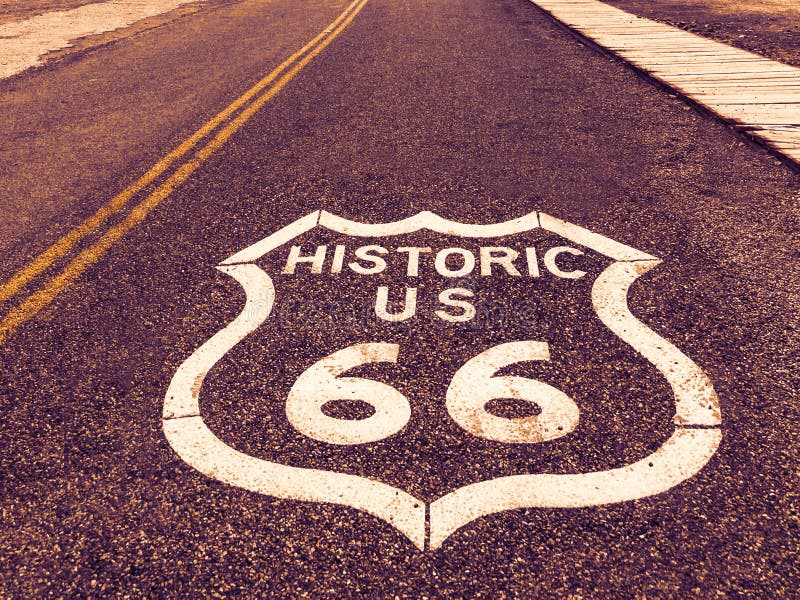 Historic US Route 66 highway sign on asphalt in Oatman, Arizona, United States. The picture was made during a motorcycle road trip through the south western states of USA. Historic US Route 66 highway sign on asphalt in Oatman, Arizona, United States. The picture was made during a motorcycle road trip through the south western states of USA.