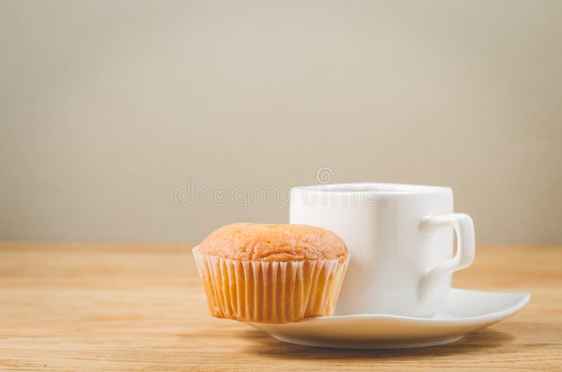 Muffin and Coffee for Breakfast on a Dark Background with Copy Space