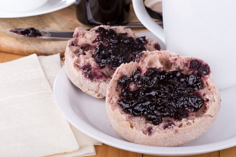 Muffin inglesi con l'inceppamento del mirtillo immagini stock libere da diritti Muffin inglesi con l'inceppamento del mirtillo immagini stock libere da diritti