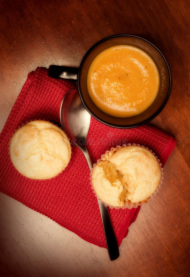 Mug of butternut bisque and corn muffins