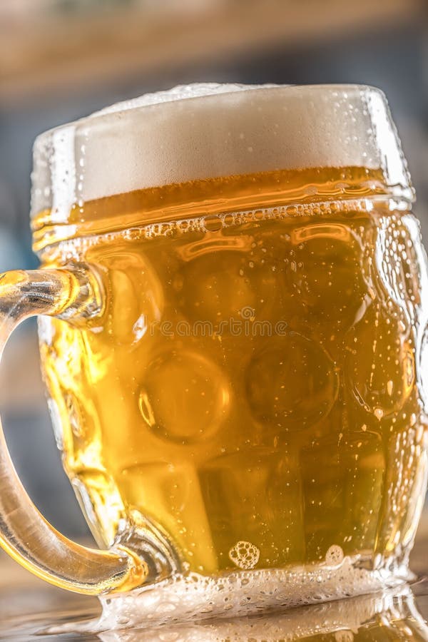 Mug of Cold Beer on Bar Counter in Pub or Restaurant Stock Photo
