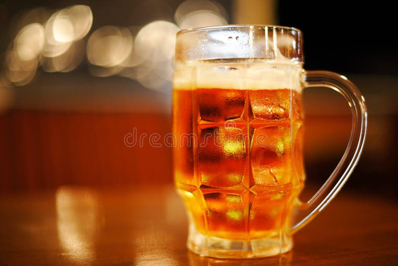 Mug of cold light golden beer royalty free stock images