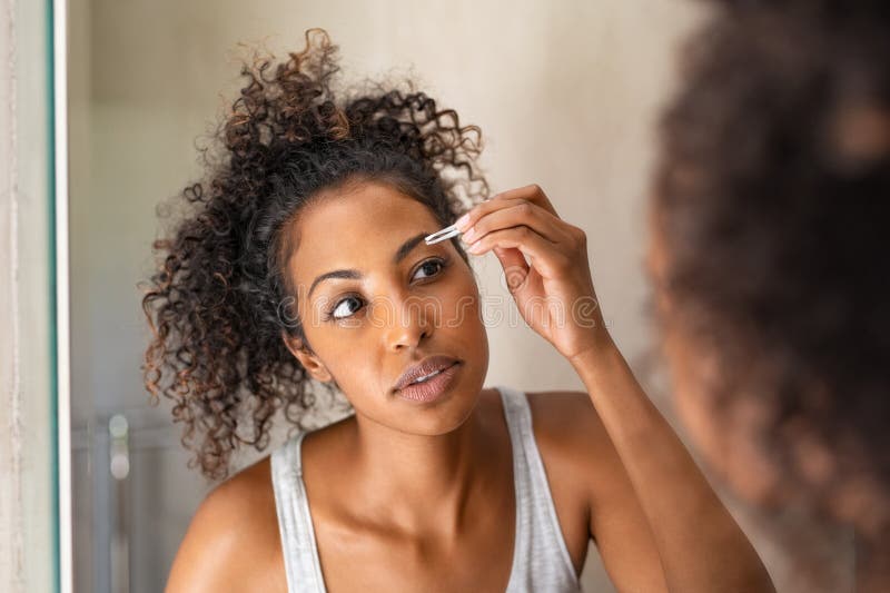 Mujer africana desplumando cejas imágenes de archivo libres de regalías