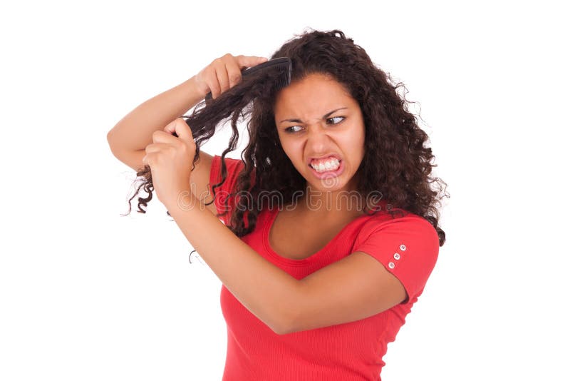 Young african american woman combing hair isolated. Young african american woman combing hair isolated