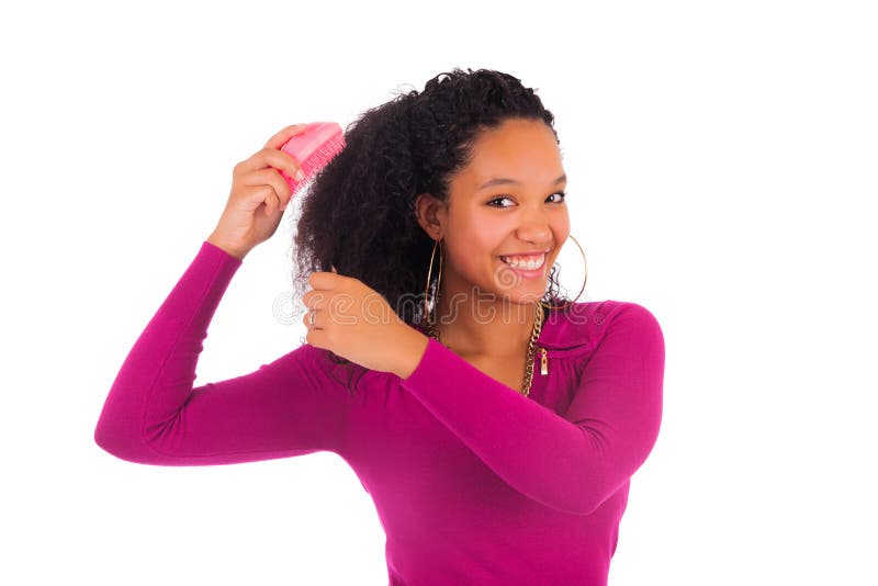 Young african american woman combing hair isolated. Young african american woman combing hair isolated