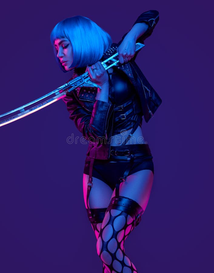 Studio shot of aggressive and fashion woman in cyberpunk style in fight stance. Studio shot of aggressive and fashion woman in cyberpunk style in fight stance.