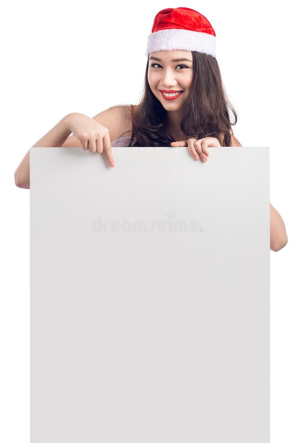 Mujer asiática joven de la Navidad que muestra la muestra en blanco de la bandera de la cartelera imagenes de archivo Mujer asiática joven de la Navidad que muestra la muestra en blanco de la bandera de la cartelera imagenes de archivo