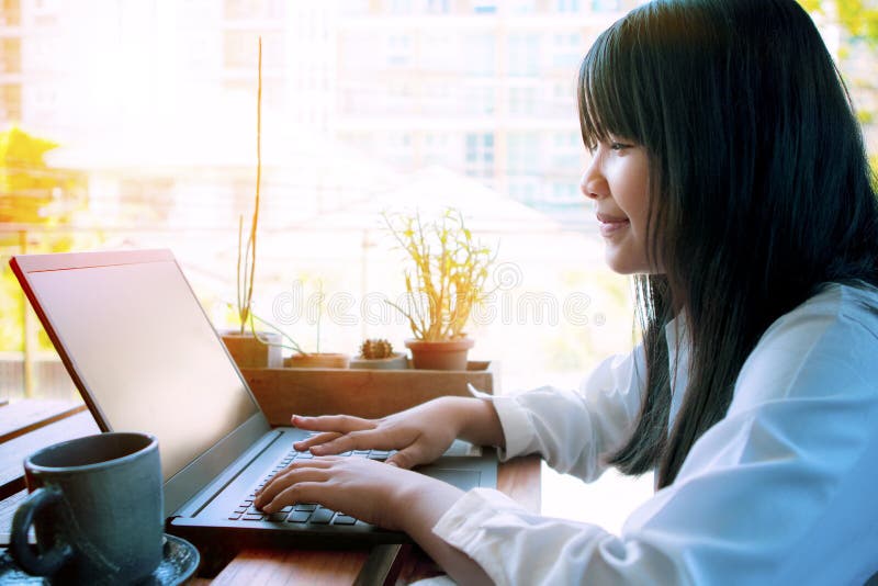 Asian woman working on computer  laptop at home terrace. Asian woman working on computer  laptop at home terrace