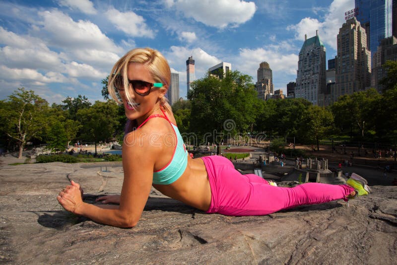 Young Blonde fit Athletic woman exercising in Central Park. Young Blonde fit Athletic woman exercising in Central Park
