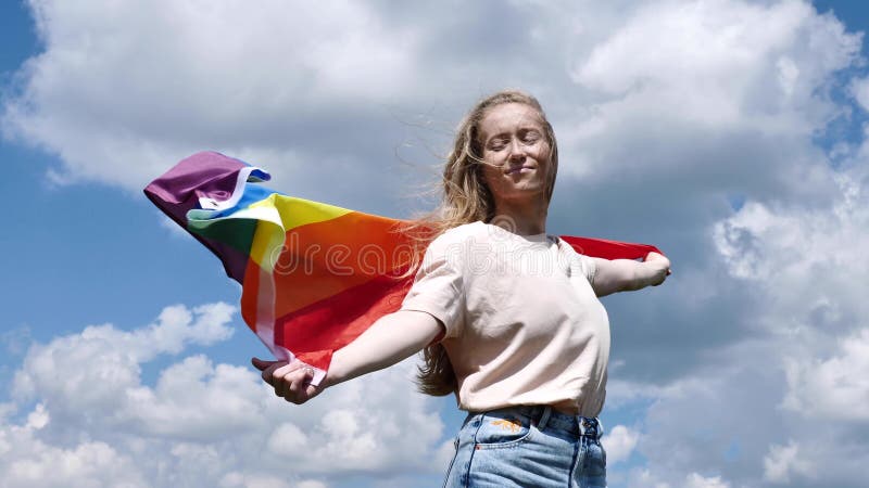 Mujer bisexual con bandera lgbt en el fondo del cielo