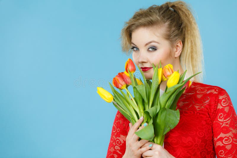 Mujer bonita con tulipanes amarillos rojos fotografía de archivo