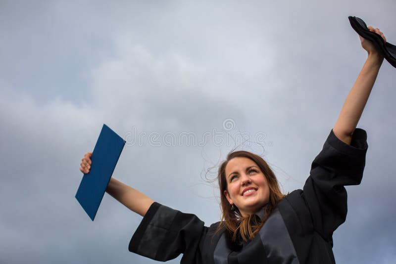 Mujer bonita, joven que celebra alegre su graduación foto de archivo libre de regalías Mujer bonita, joven que celebra alegre su graduación foto de archivo libre de regalías