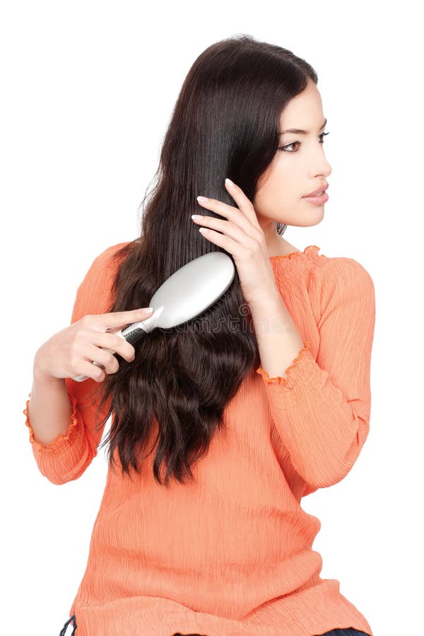 Pretty woman combing her long black hair, isolated on white background. Pretty woman combing her long black hair, isolated on white background