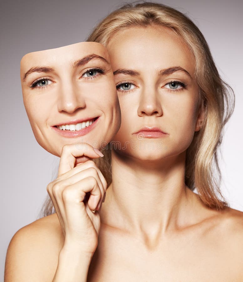 Woman hiding under the happy mask. Hypocritical, insincere, two-faced female. Woman hiding under the happy mask. Hypocritical, insincere, two-faced female