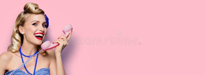 Mujer con el tubo de teléfono. Roscados encima de la niña. La moda vintage y retro. Rosa pastel. El espacio de la copia fotografía de archivo libre de regalías
