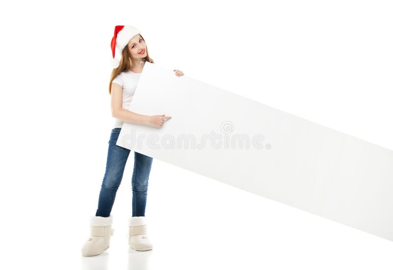 Mujer de la Navidad en el sombrero de santa que señala al tablero vacío fotografía de archivo libre de regalías Mujer de la Navidad en el sombrero de santa que señala al tablero vacío fotografía de archivo libre de regalías