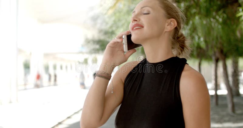 Mujer de negocios bonita que usa el teléfono celular almacen de metraje de vídeo