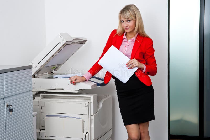 Mujer de negocios que trabaja en la impresora de oficina fotografía de archivo libre de regalías Mujer de negocios que trabaja en la impresora de oficina fotografía de archivo libre de regalías
