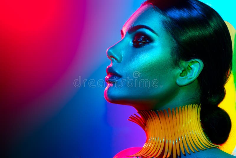 Mujer del modelo de moda en la presentación brillante colorida de las luces Retrato de la muchacha atractiva con maquillaje de mo