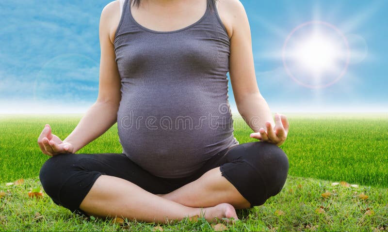 Mujer embarazada asiática sana que hace yoga imágenes de archivo libres de regalías Mujer embarazada asiática sana que hace yoga imágenes de archivo libres de regalías