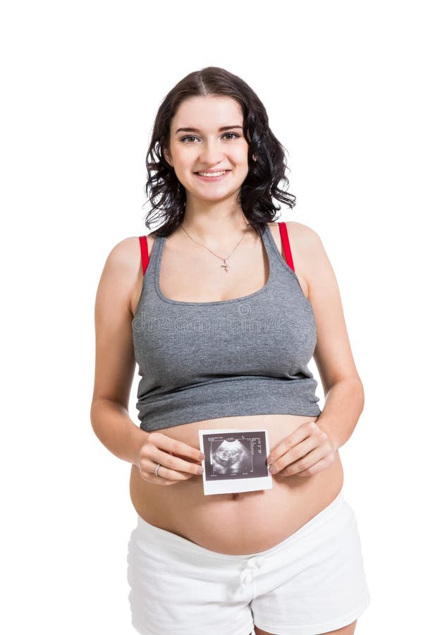 Mujer embarazada que exhibe un ultrasonido prenatal imagen de archivo Mujer embarazada que exhibe un ultrasonido prenatal imagen de archivo