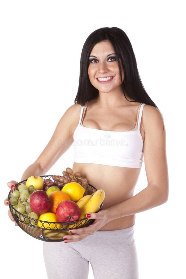 Mujer en fruta de la explotación agrícola del sujetador de los deportes fotografía de archivo Mujer en fruta de la explotación agrícola del sujetador de los deportes fotografía de archivo