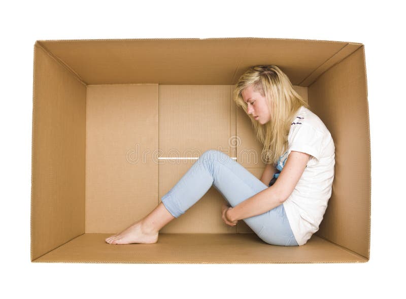 Woman siting in a cardboard box isolated on white background. Woman siting in a cardboard box isolated on white background