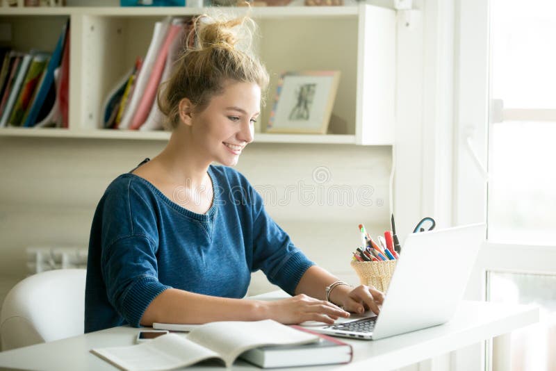 Mujer feliz que trabaja en hogar-oficina acogedora fotografía de archivo