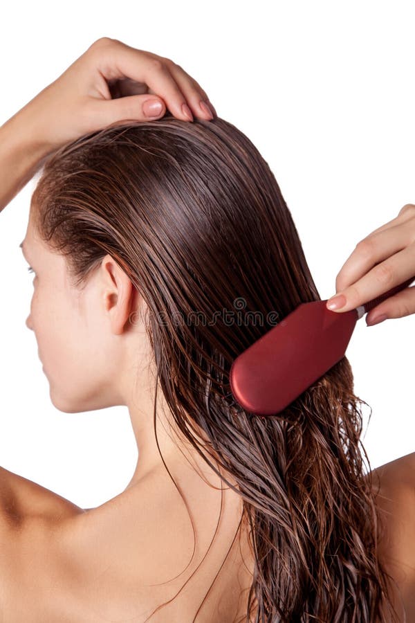 Young beautiful woman with white towel and freckles combing her brown wet hair after showering. studio shot. isolated on white background. Young beautiful woman with white towel and freckles combing her brown wet hair after showering. studio shot. isolated on white background.