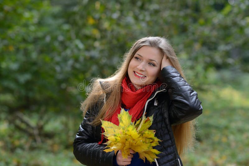 Mujer joven con las hojas de otoño a disposición imágenes de archivo libres de regalías Mujer joven con las hojas de otoño a disposición imágenes de archivo libres de regalías