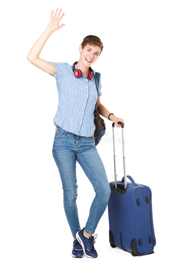 Mujer joven feliz con los bolsos del viaje que agitan su mano hola fotos de archivo Mujer joven feliz con los bolsos del viaje que agitan su mano hola fotos de archivo
