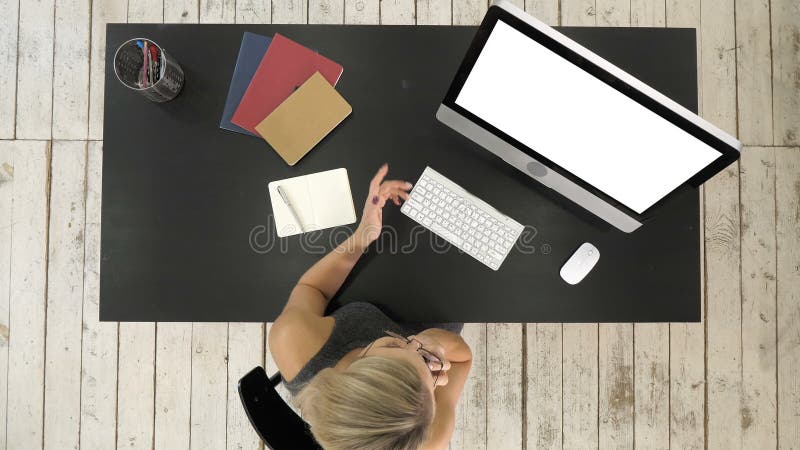 Mujer joven hermosa que habla en el teléfono elegante, usando el ordenador Visualización blanca