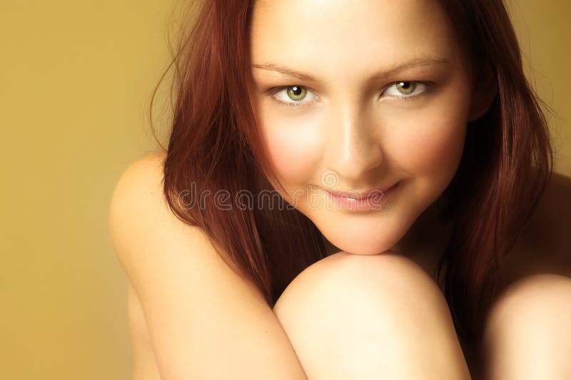 Young woman with red hair and green eyes sitting. Young woman with red hair and green eyes sitting