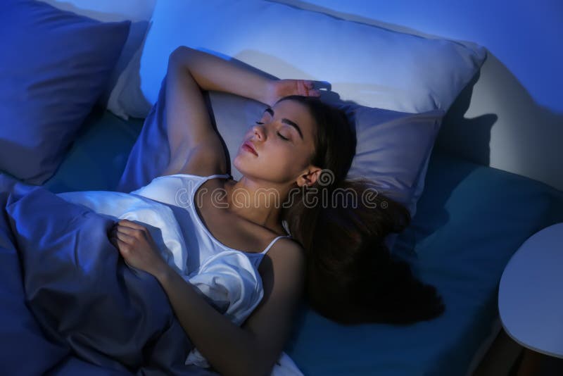 Young woman sleeping on soft pillow at night. Bedtime. Young woman sleeping on soft pillow at night. Bedtime